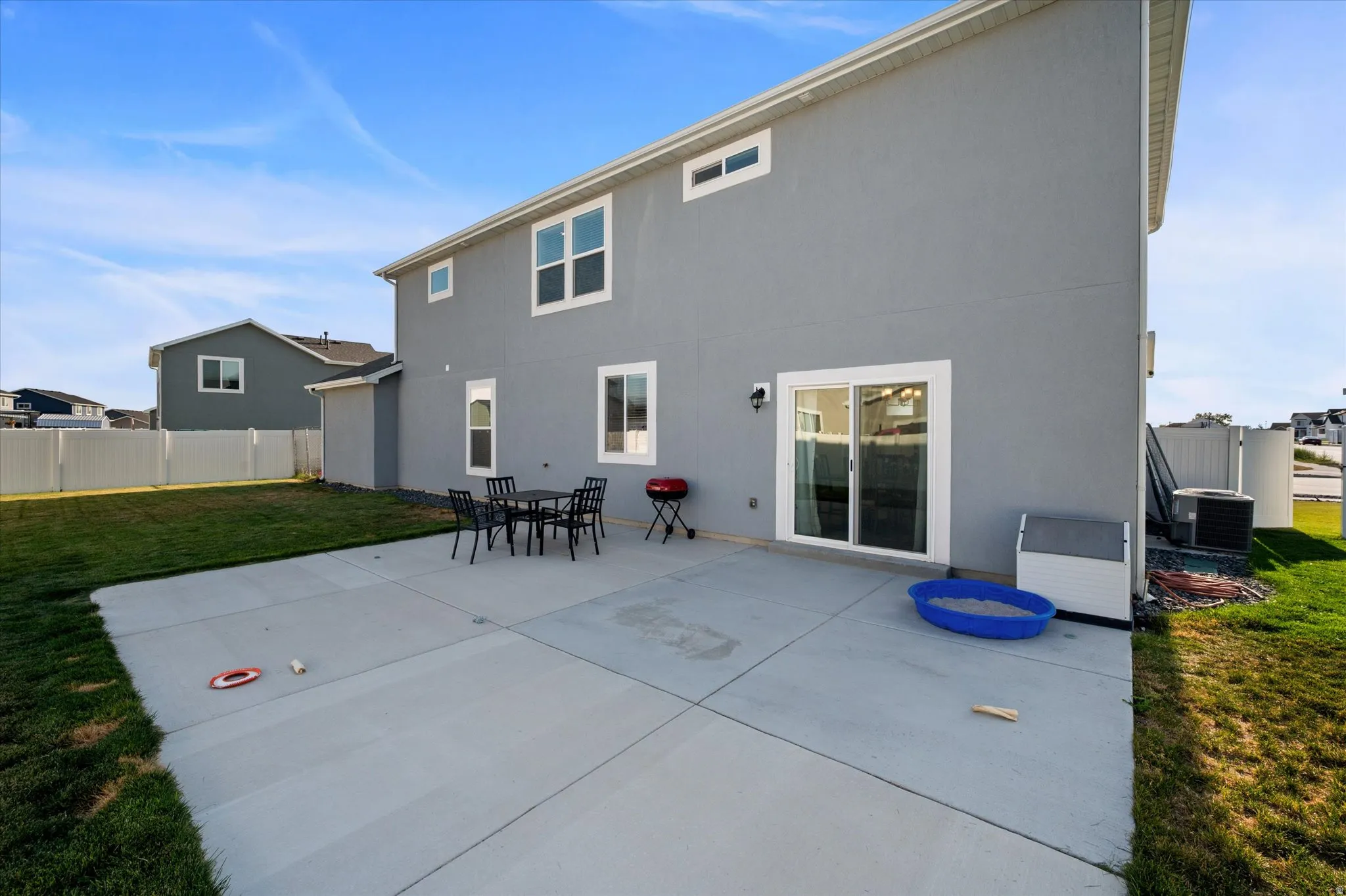 Expansive concrete patio with direct access to the interior via a sliding glass door