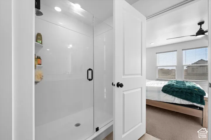 Walk-in shower with clear glass enclosure and black hardware