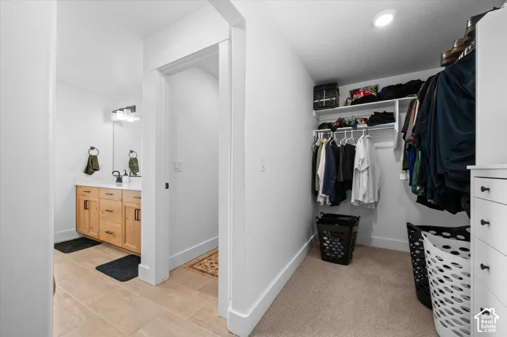 Bathroom with a wood-finish vanity, white quartz countertop