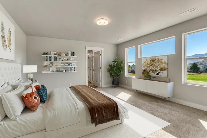 Spacious room featuring multiple large windows, ample natural light, soft carpeting, and built-in shelving