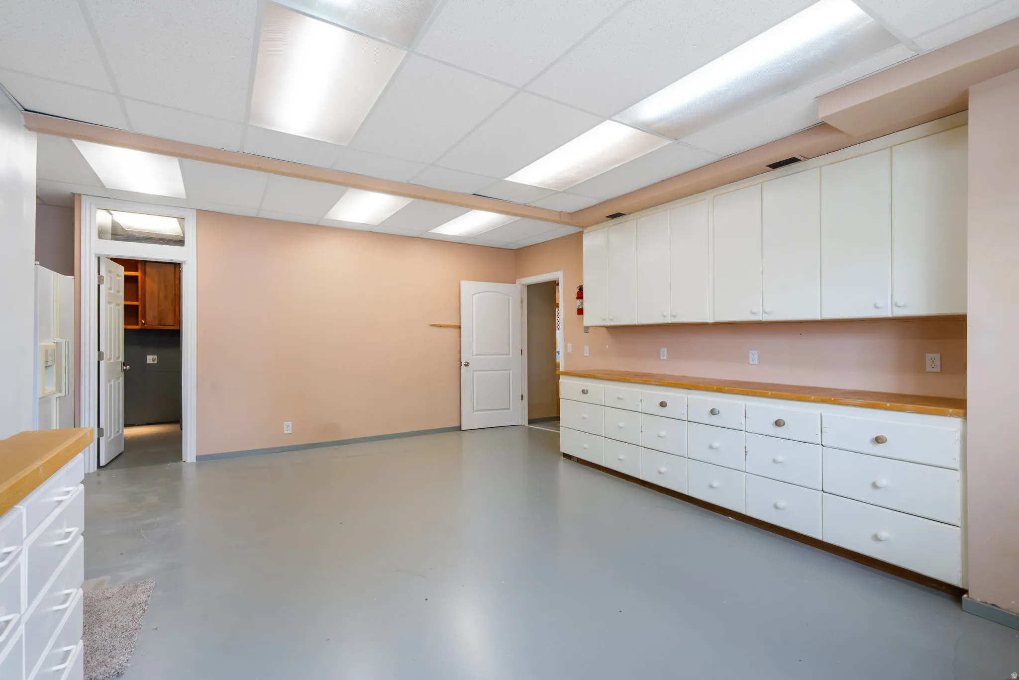 Another view of large lower FLEX room. Currently a workshop but can be converted into a 5th bedroom or even better a second kitchen (buyer to verify)
