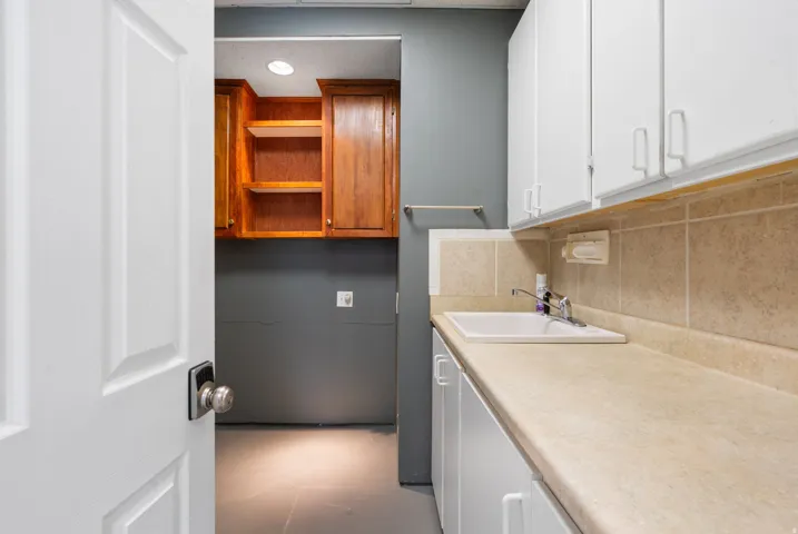 Located off current workshop is a functional utility room makes clean up easy.
