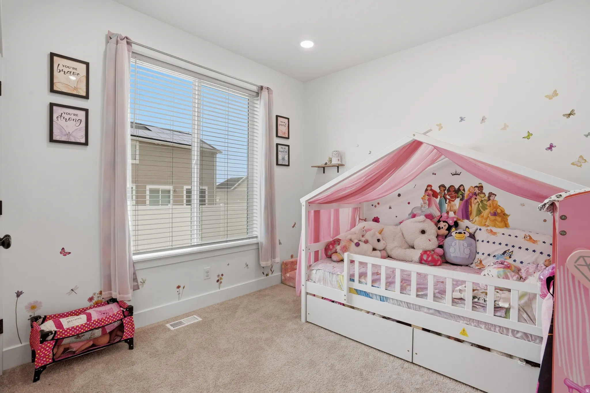 Bedroom featuring a large window with blinds, recessed lighting, and soft carpet flooring