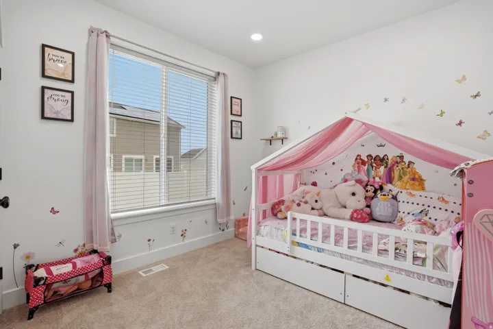 Bedroom featuring a large window with blinds, recessed lighting, and soft carpet flooring