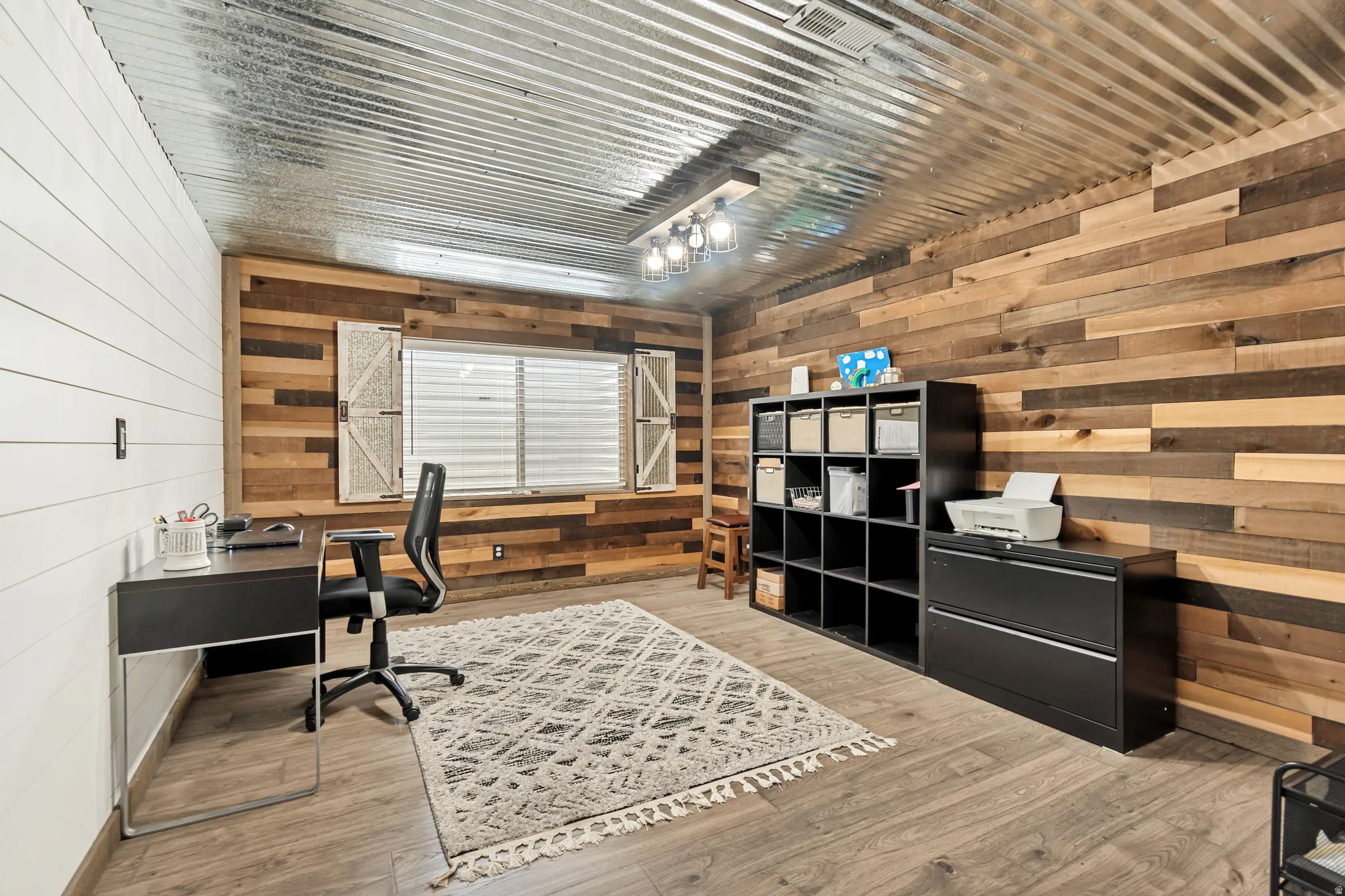 Corrugated metal ceiling paired with wood-finish flooring