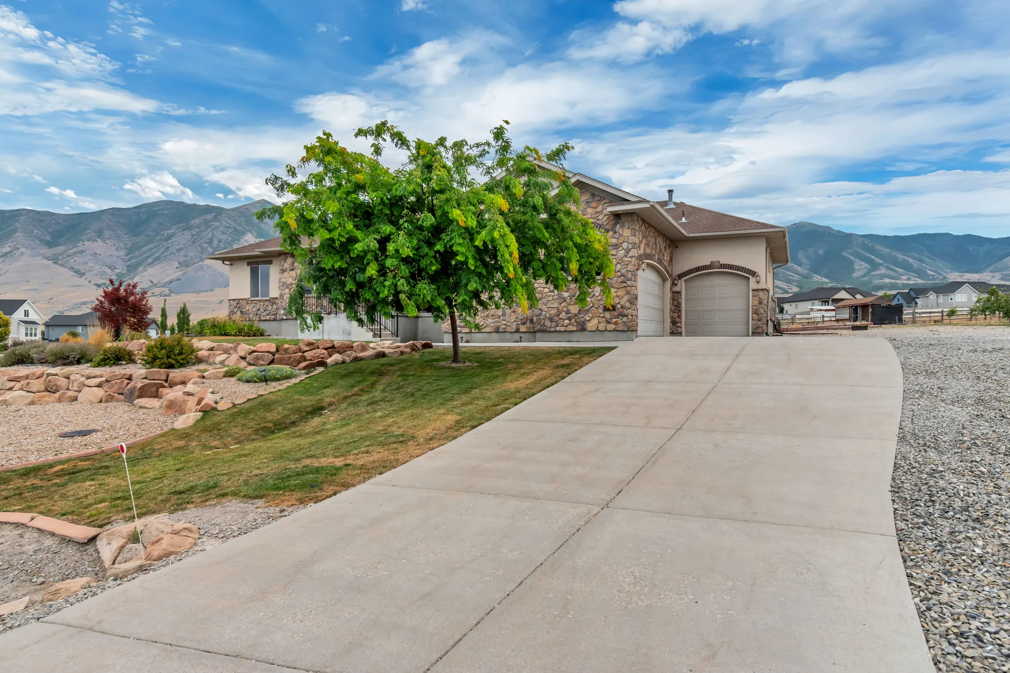 Stone veneer exterior with an attached two-car garage