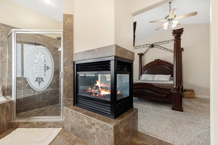 Two-sided fireplace featuring a tiled surround and hearth