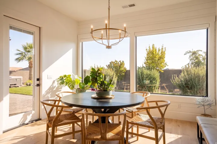 Bright interior with wood-finish flooring and a contemporary chandelier