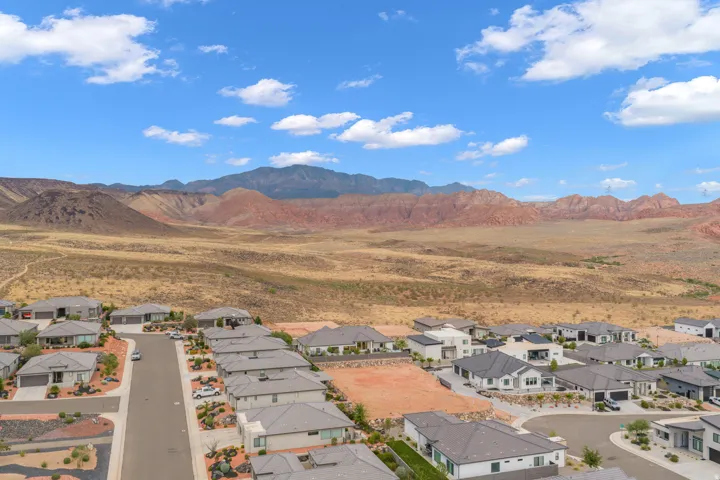 Residential development featuring contemporary single-story homes with grey roofing and desert landscaping