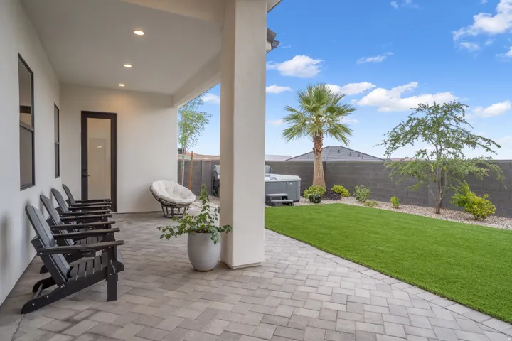 Covered patio featuring recessed lighting and a paver stone surface