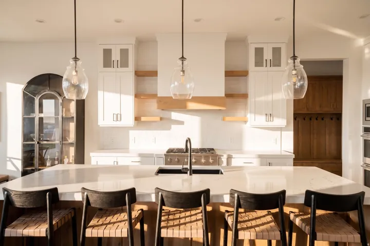 Expansive kitchen island with a light-toned countertop and integrated sink