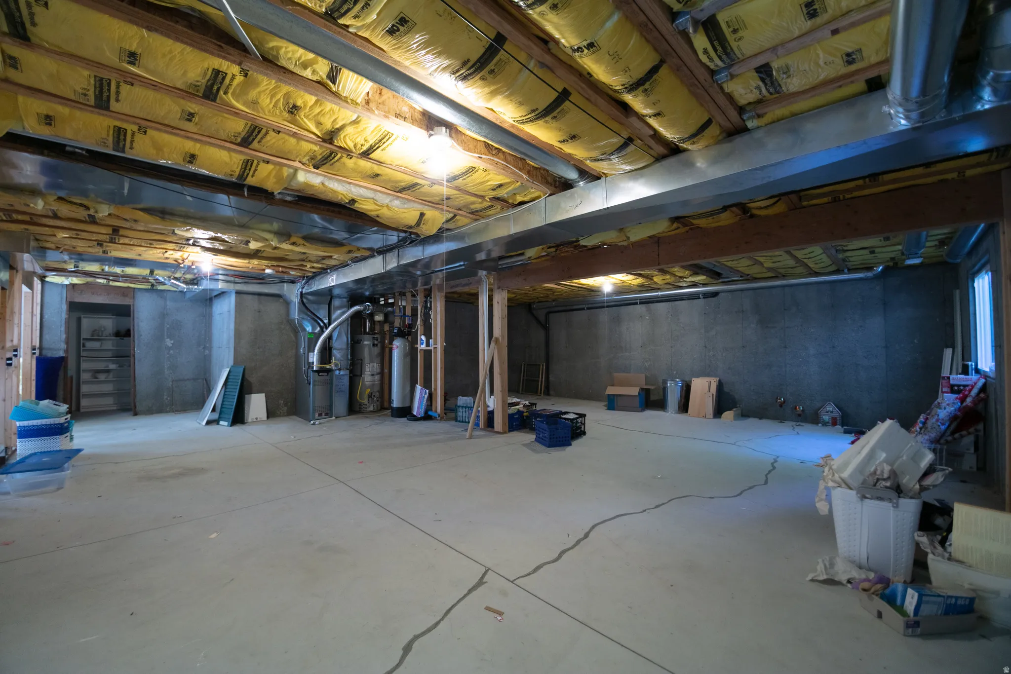 Unfinished basement with concrete flooring and exposed ceiling joists