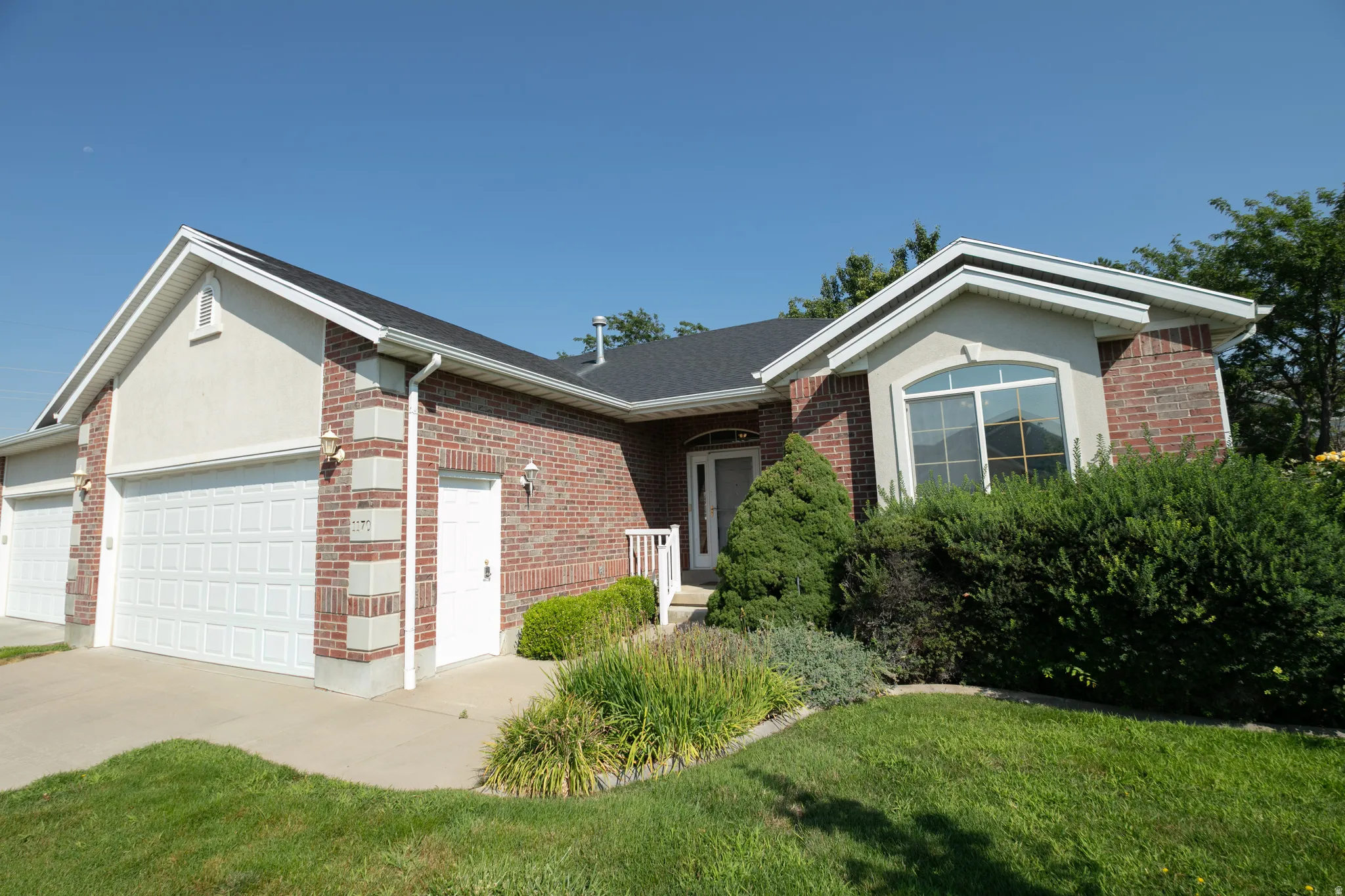 Brick and stucco exterior with multiple gables