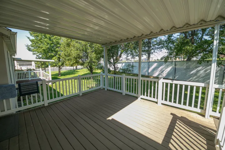 Expansive covered deck with composite decking and white railings