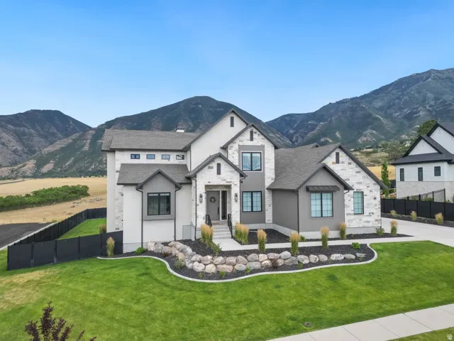 Modern architectural design featuring a light-colored stone and stucco exterior