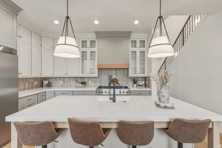 Spacious kitchen island featuring a light-toned countertop and built-in seating