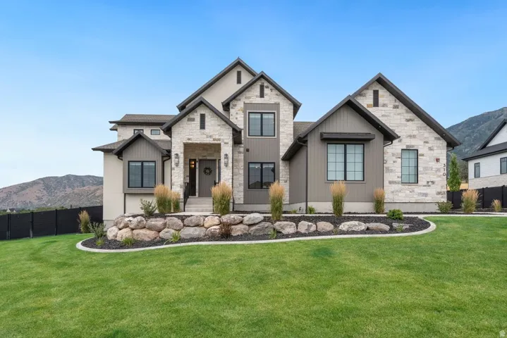 Contemporary home exterior featuring stone and vertical siding accents