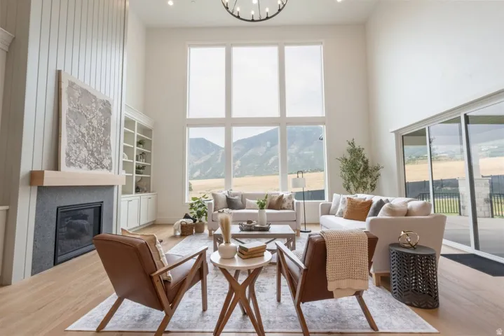 Grand living area featuring a vaulted ceiling and floor-to-ceiling windows