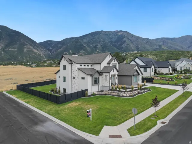 Modern two-story residence with white stucco and light gray stone veneer accents