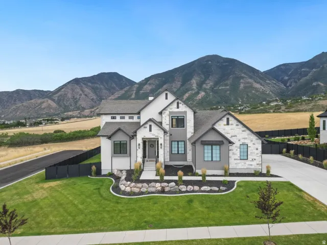 Contemporary two-story residence featuring a striking stone and siding exterior