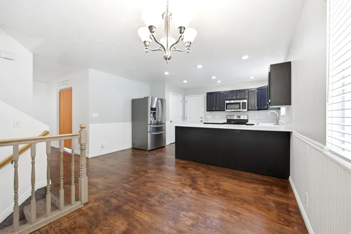 Open-concept kitchen and dining area featuring wood-finish flooring