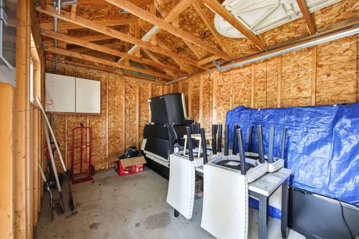 Exposed wood framing and concrete flooring in a utility space