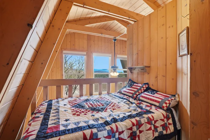 Vaulted wood-paneled ceilings with exposed beams, wood-plank walls, and wood-finish flooring