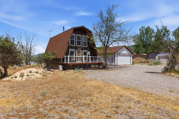 A-frame residence with a prominent front deck and ample parking