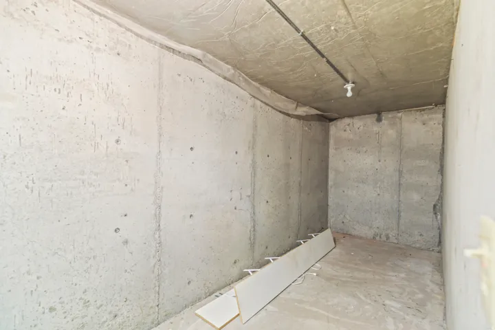 Unfinished room featuring concrete walls and ceiling