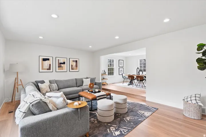 Bright living space featuring recessed lighting and light wood-finish flooring