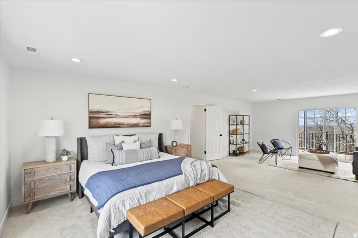 Spacious room with light-colored carpeting, recessed lighting, and white walls