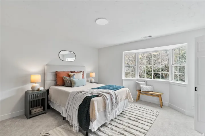 Neutral tone walls and carpeting create a bright interior