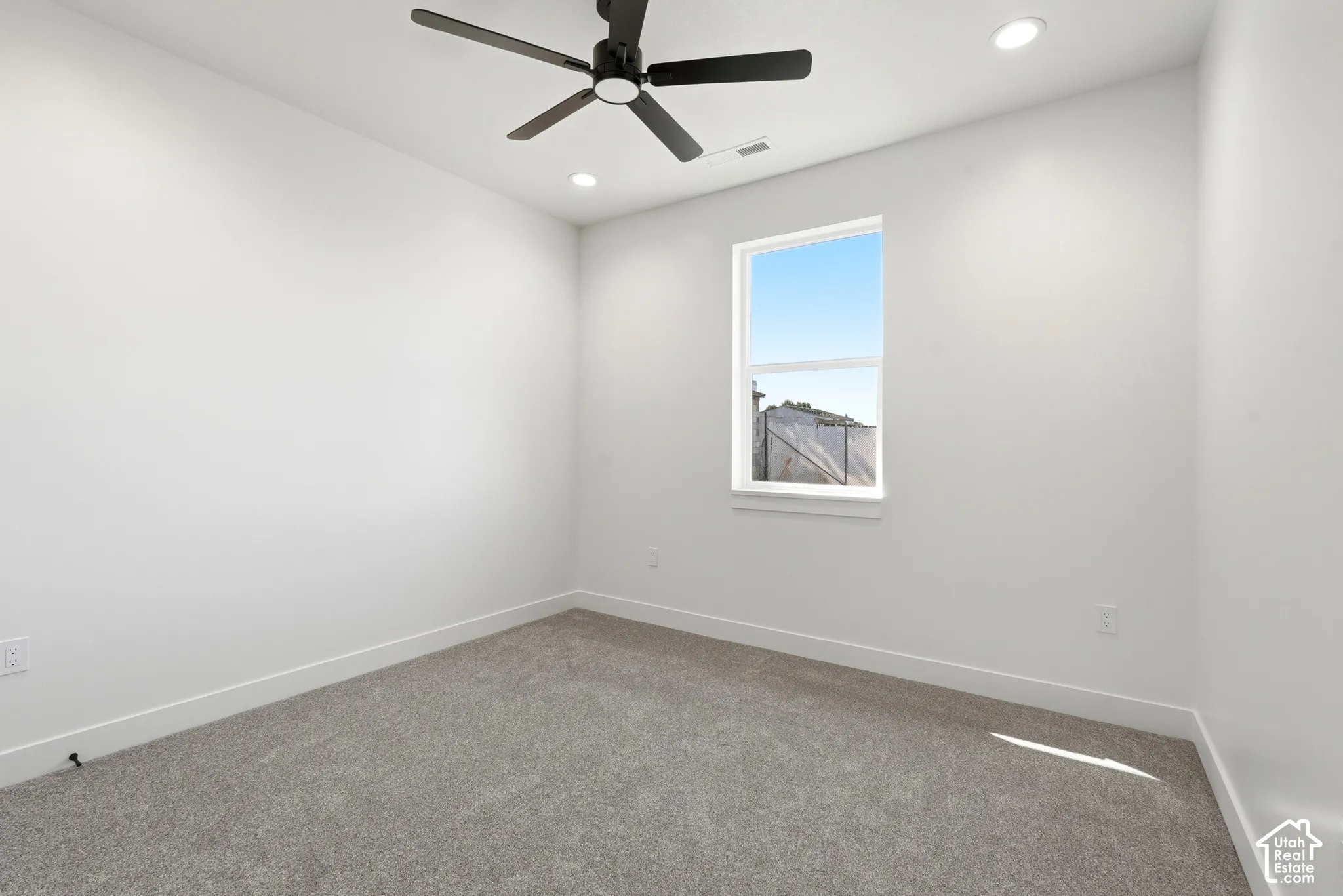 Recessed lighting, ceiling fan, white trim, white walls, and gray carpet