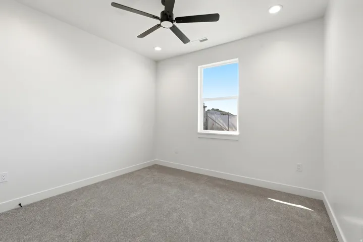 Recessed lighting, ceiling fan, white trim, white walls, and gray carpet