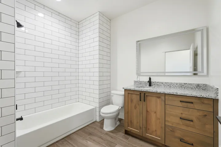 White subway tile shower surround with integrated shelf