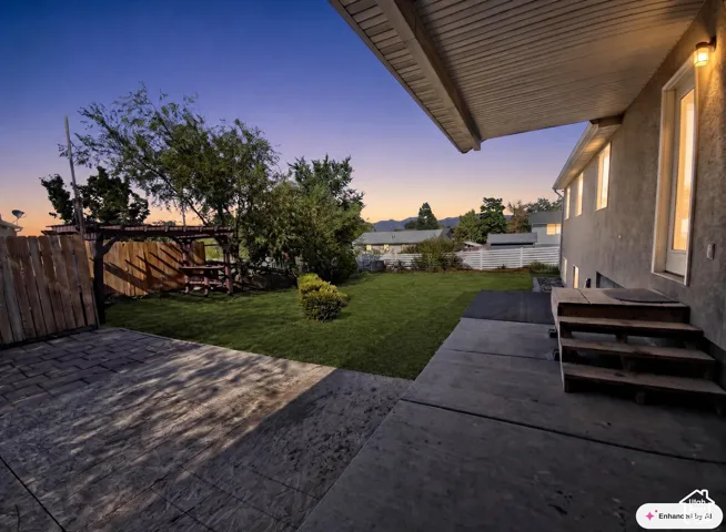 Expansive backyard featuring a concrete patio, wooden pergola, and mature trees