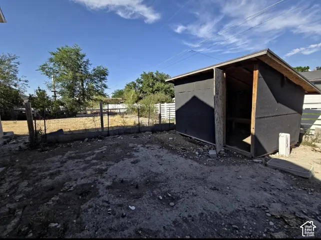 Outdoor structure featuring an open-sided design with a pitched roof and visible wood framing