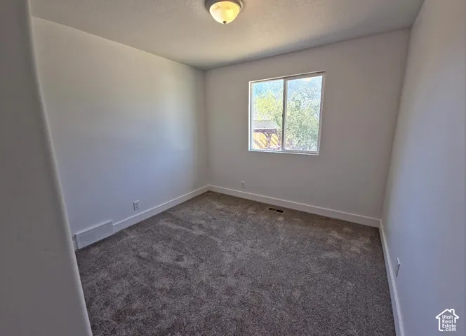Neutral wall color with white trim and grey carpet