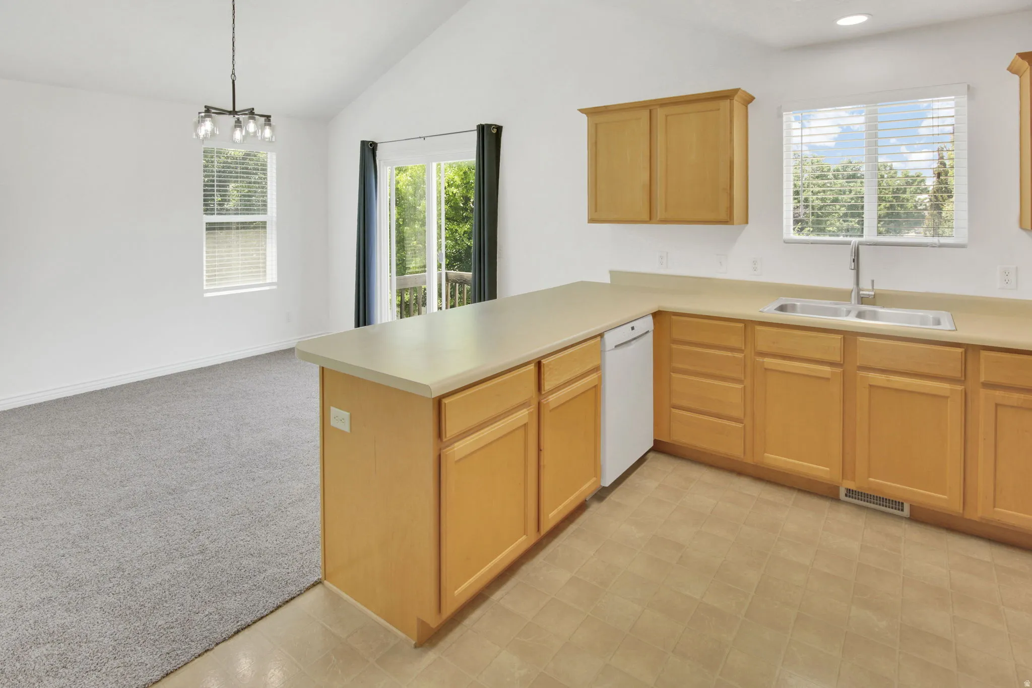 Kitchen featuring wood-finish cabinetry and light-toned countertops
