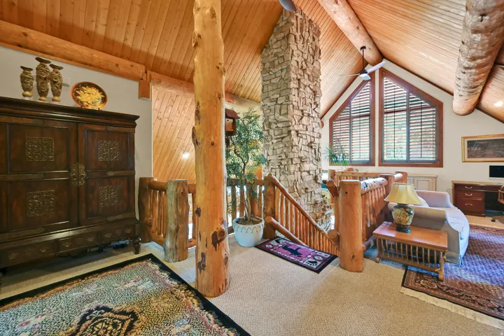 Vaulted wood-finish ceilings and exposed log beams define this interior space