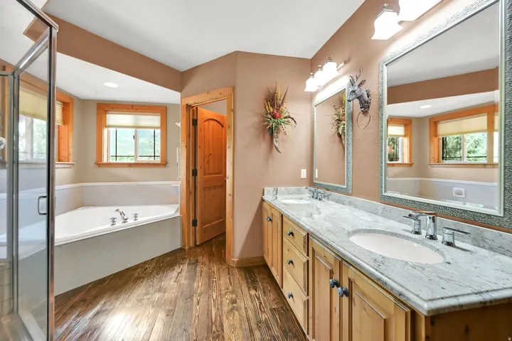 Bathroom featuring a double vanity with stone countertops, integrated sinks, and chrome fixtures