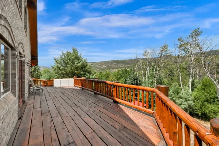 Expansive wood deck with a natural wood log railing