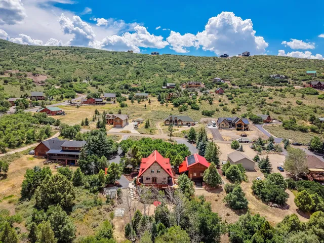 Expansive hillside community featuring numerous residences nestled among natural foliage