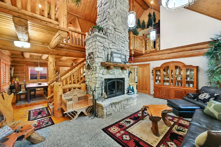 Stone fireplace with hearth and wood mantel