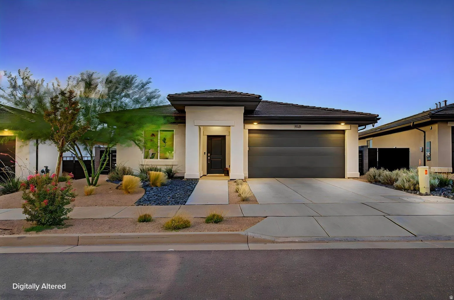 Contemporary single-story residence featuring a dark gray garage door, a black entry door, and light stucco exterior