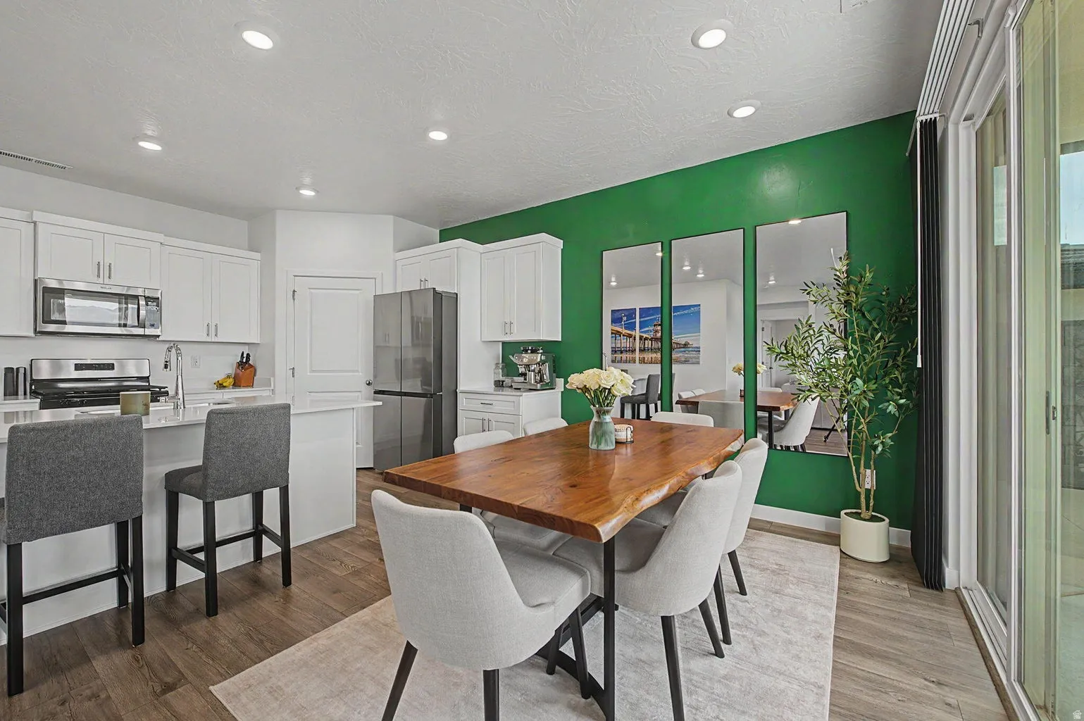 Open-concept kitchen and dining area featuring wood-finish flooring