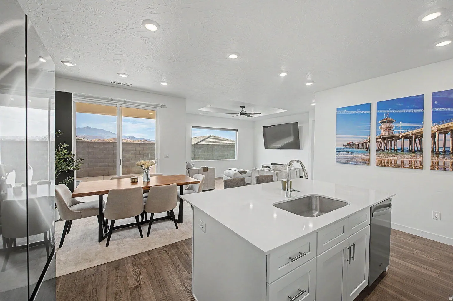 Open-concept interior featuring a spacious kitchen island with an undermount sink and stainless steel dishwasher