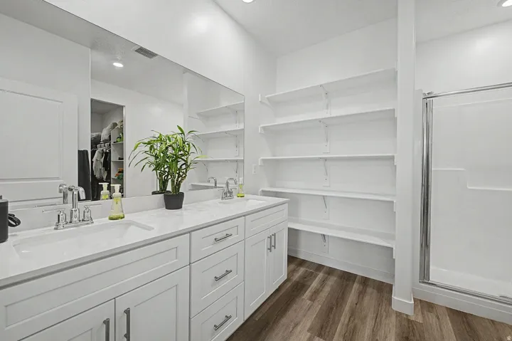 Dual vanity with white cabinetry and chrome hardware