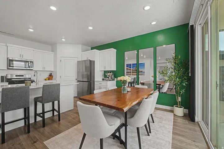 Open-concept kitchen and dining area featuring wood-finish flooring