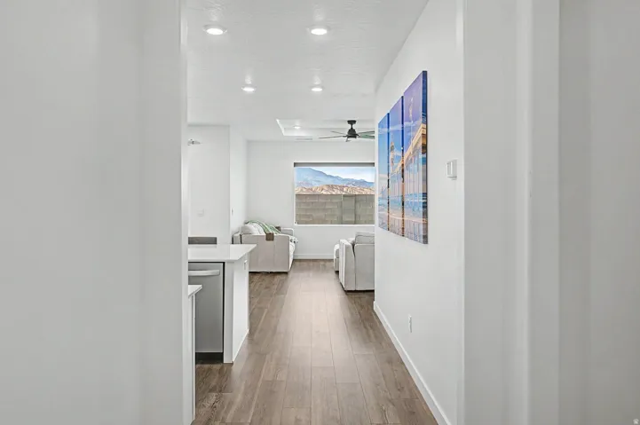 Open-concept living area featuring wood-finish flooring, recessed lighting, and a contemporary ceiling fan